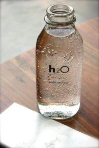 Water Bottle with h2O written on bottle.