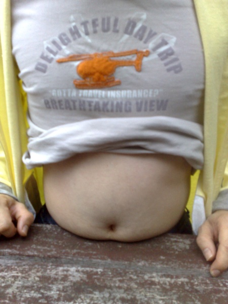 Man with T shirt Rolled up to Reveal his Belly Fat.