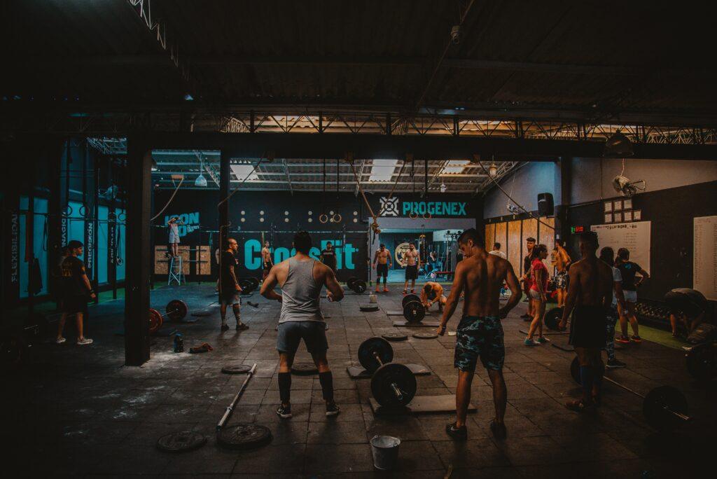 A picture looking into a Gym with Various people doing exercises