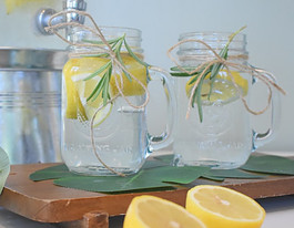 2Glass Jars Full of Water with Lemons and Mint added for flavor