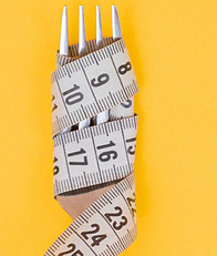 A Fork with Tape measure wrapped around the Forks.  Measure your Food